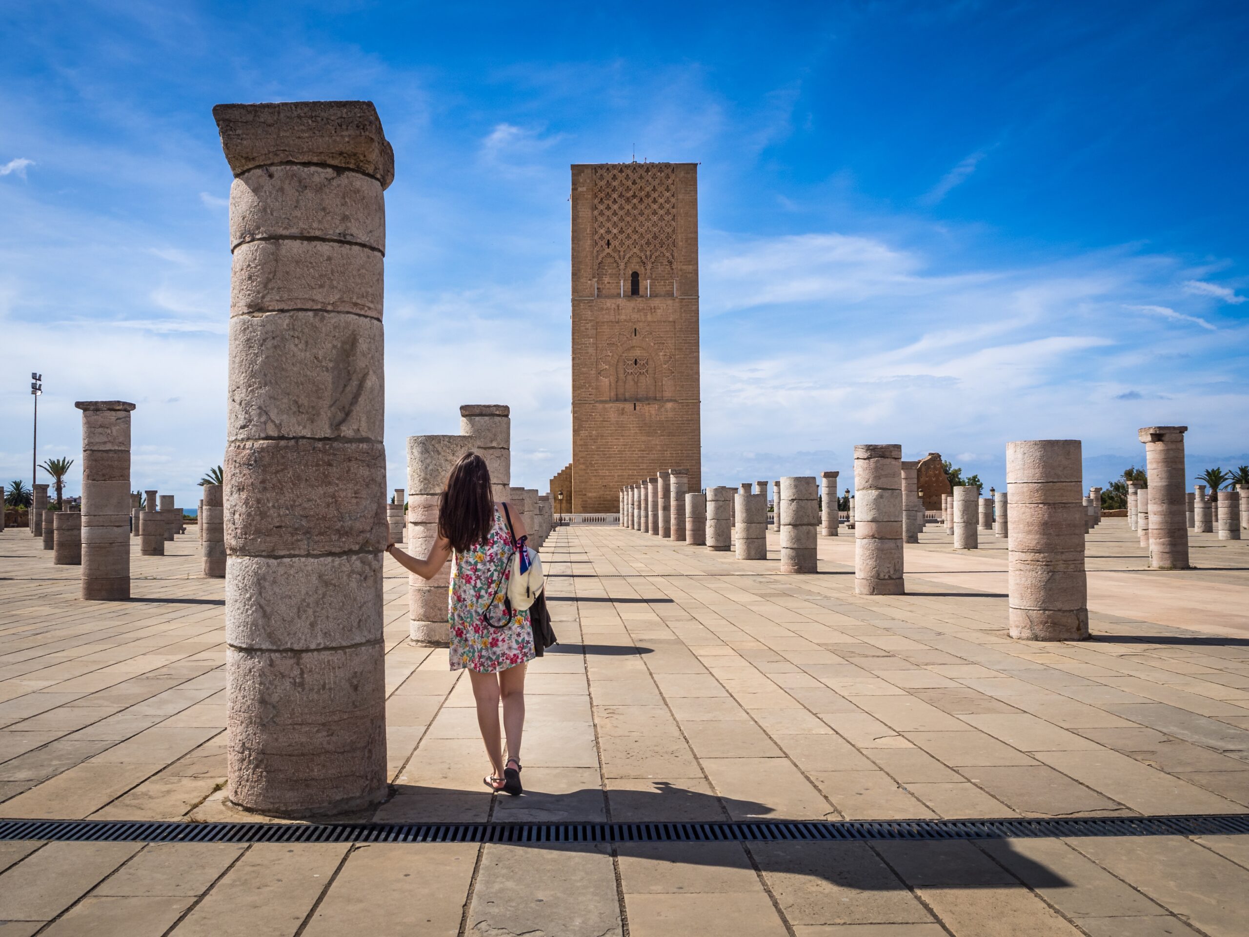 Female tourist enjoying the beautiful view of Tour Hassan in Rabat, Morocco